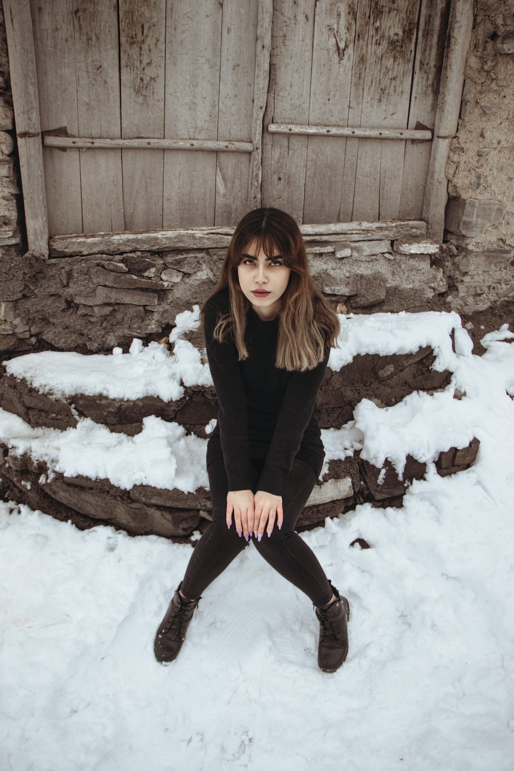 a woman sitting in the snow