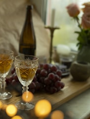 Elegant wine glasses filled with red and white wine on a cozy setting.