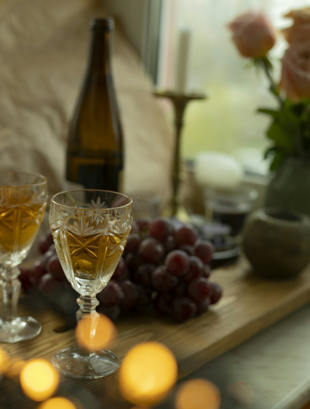 a table with wine glasses and fruit