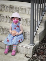 a child wearing a mask and holding a cup