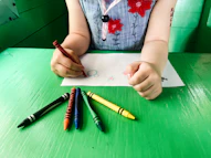 a child drawing with scissors