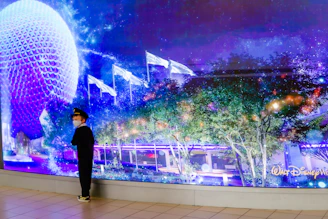 a man standing in front of a wall with lights