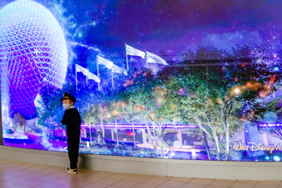 a man standing in front of a wall with lights