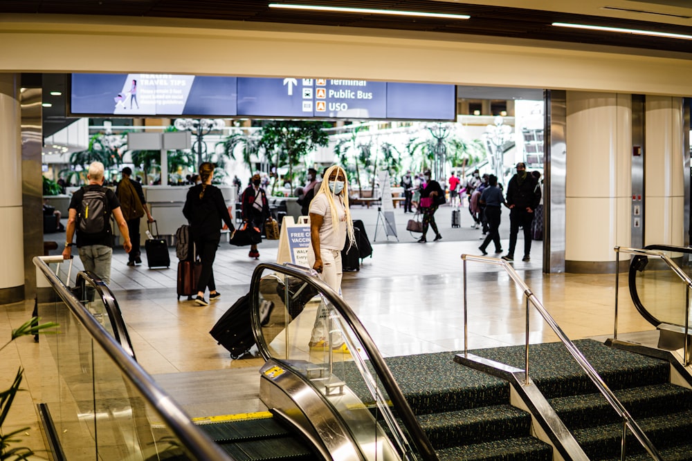 people with luggage in a terminal