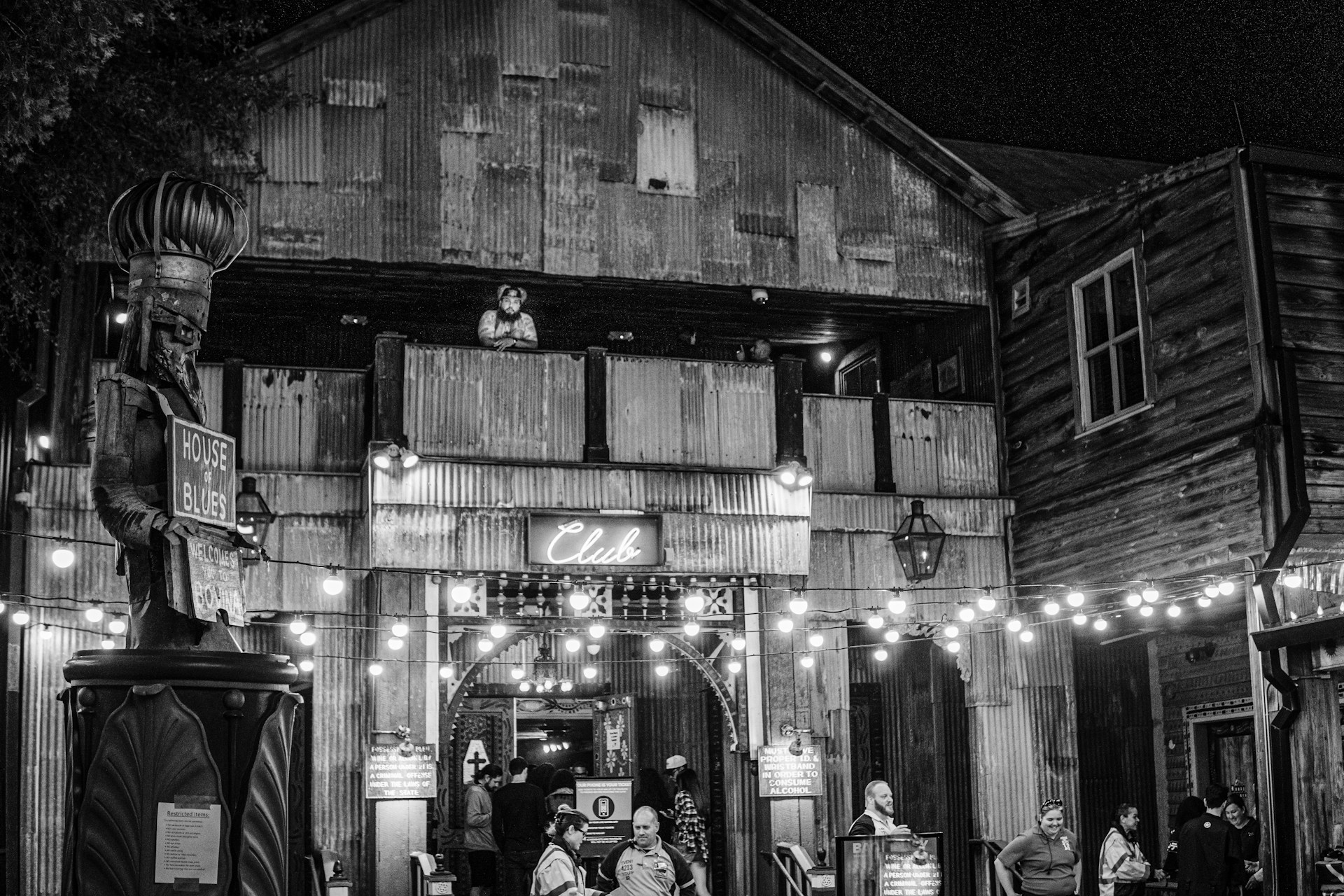 a group of people walking around a building