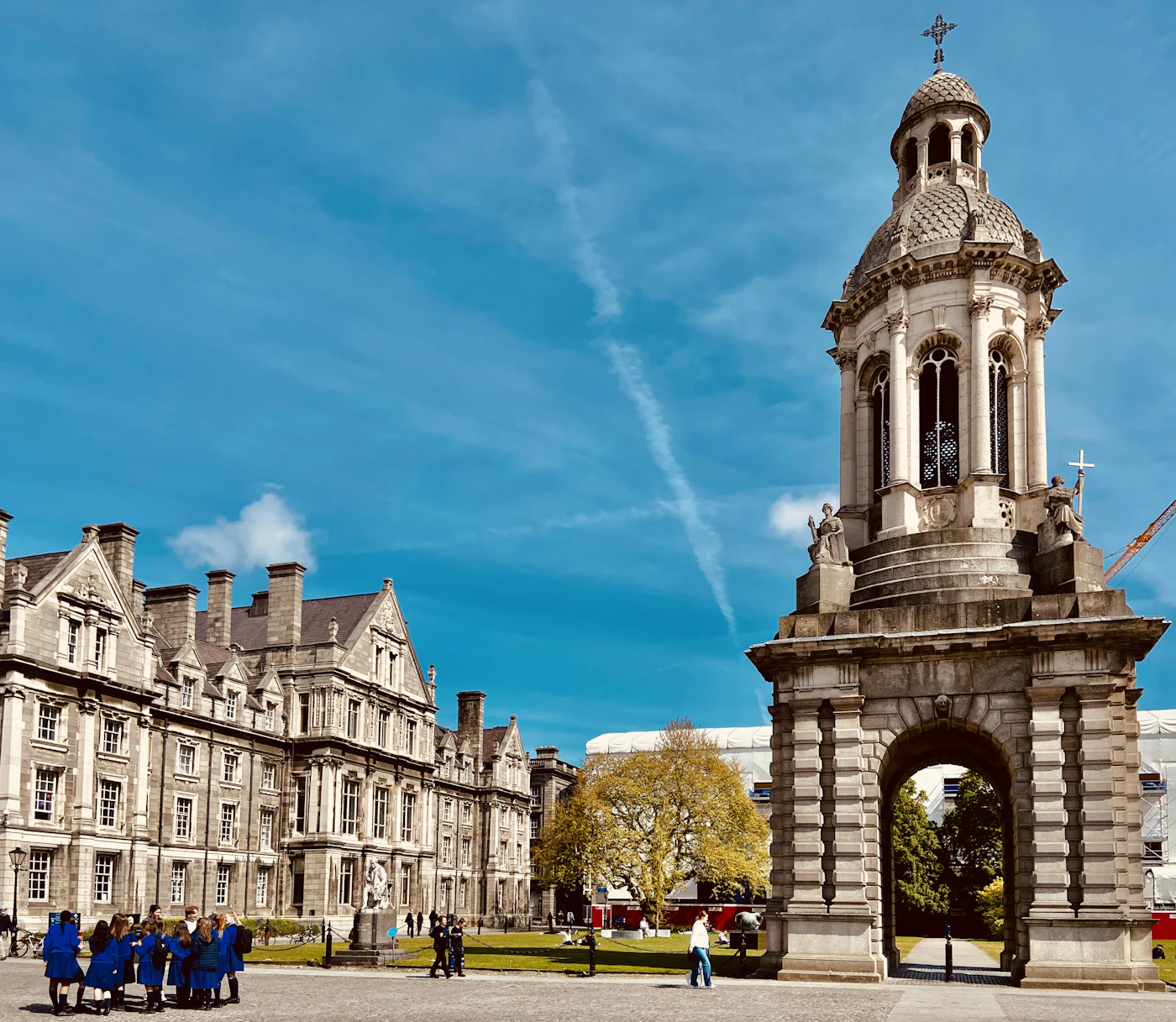 The campanile at Trinity College Dublin against a bright sky.