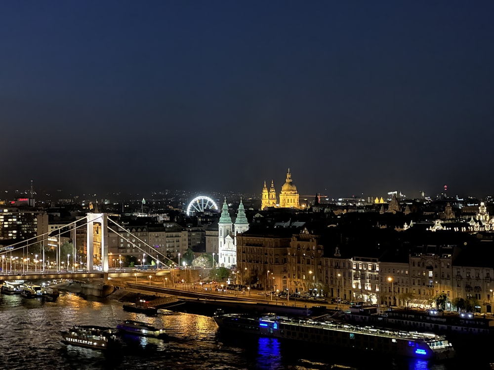 a bridge over a river with a city in the background