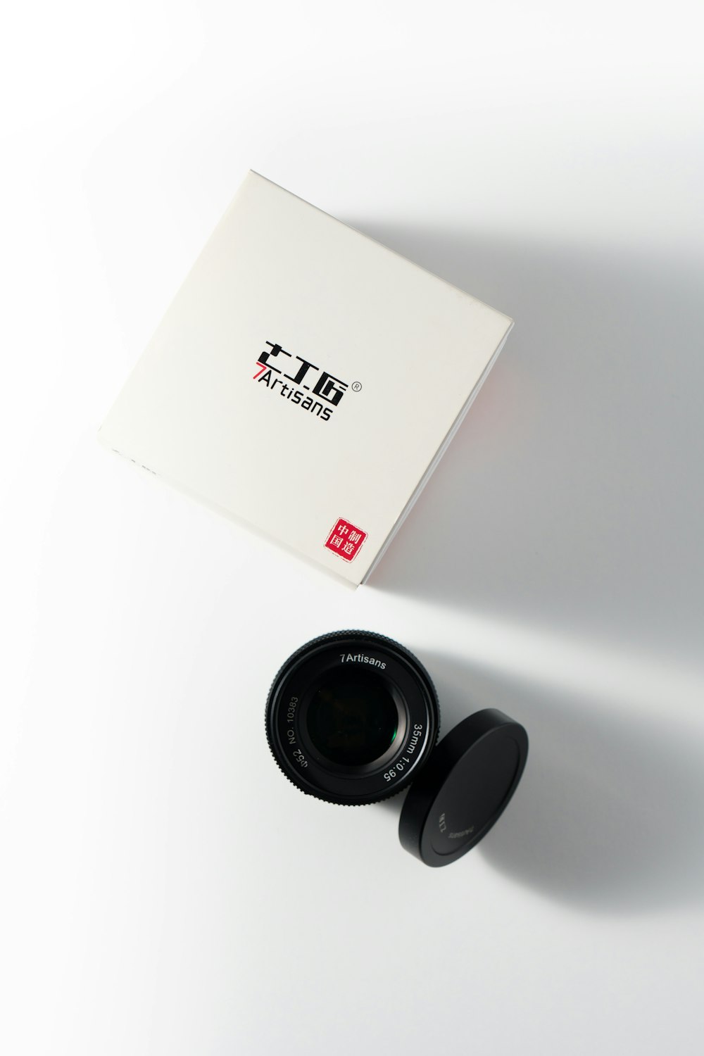 a white box with a black lens