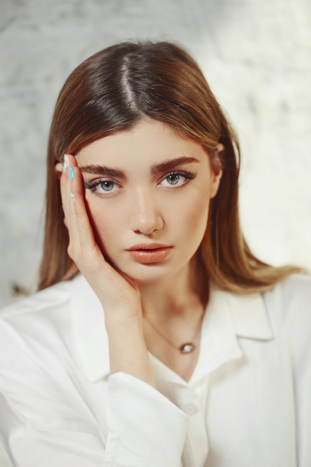 a woman with her hand on her face