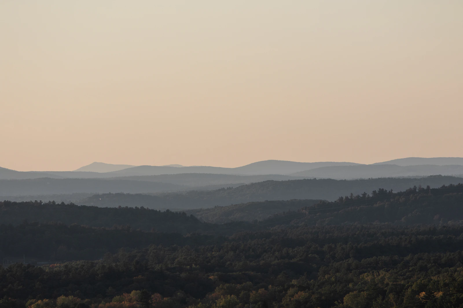 A calm landscape of rolling hills and trees in the Berkshires, ideal for a reset weekend