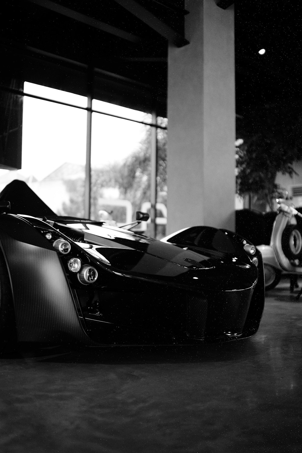 a black sports car parked in a building