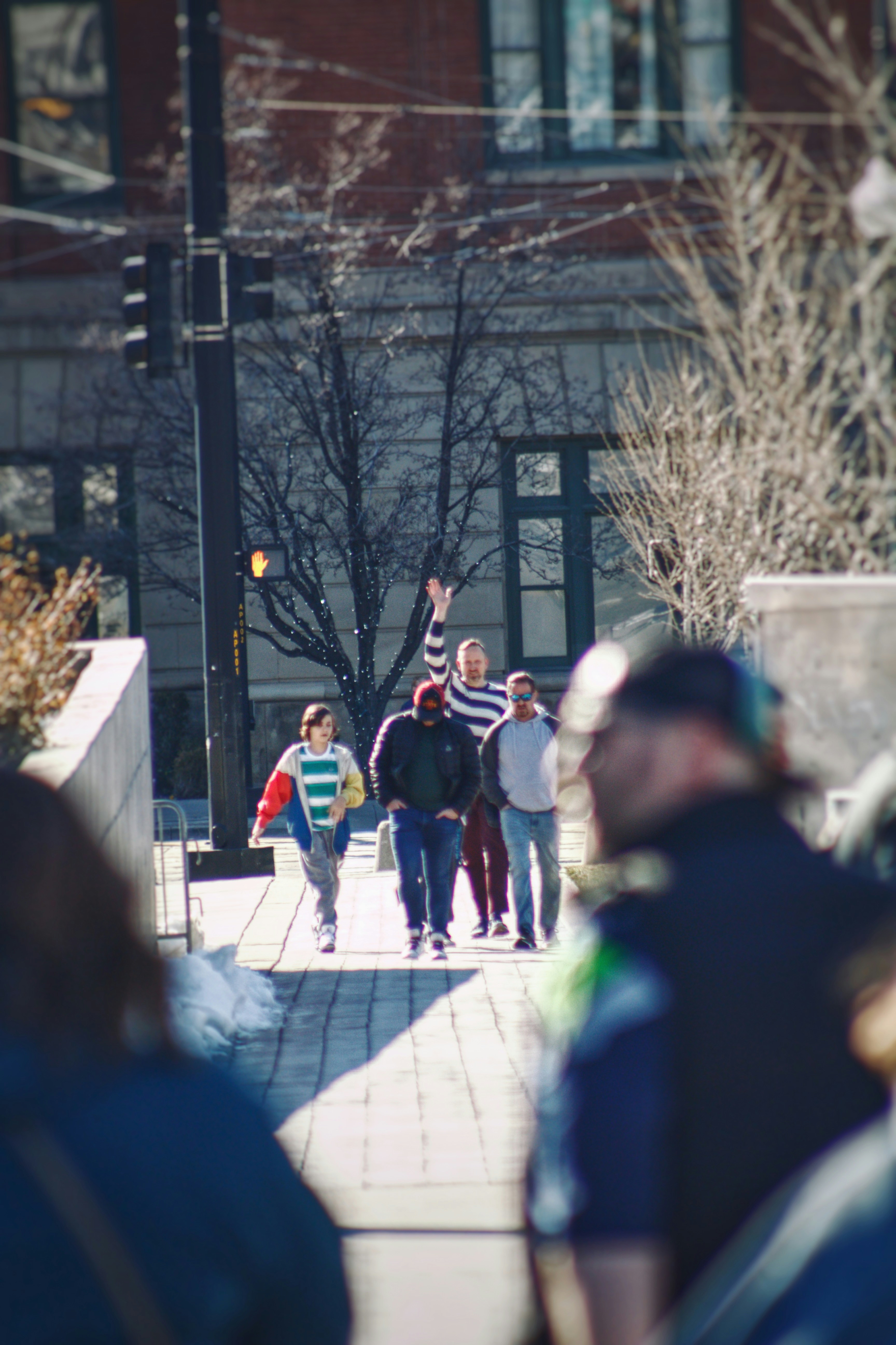 a group of people walking on a sidewalk