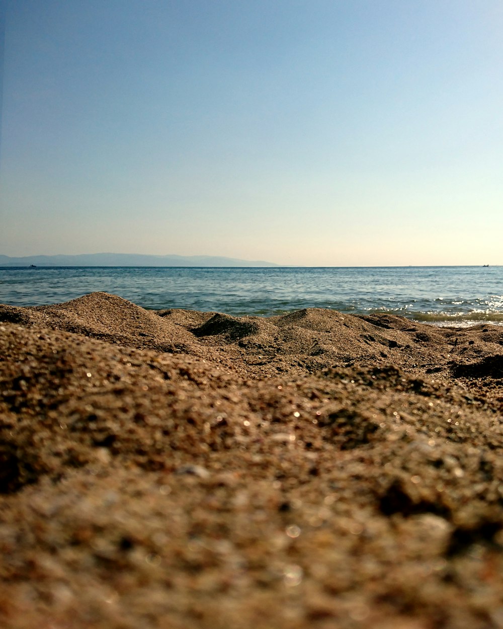 a rocky beach with water in the background