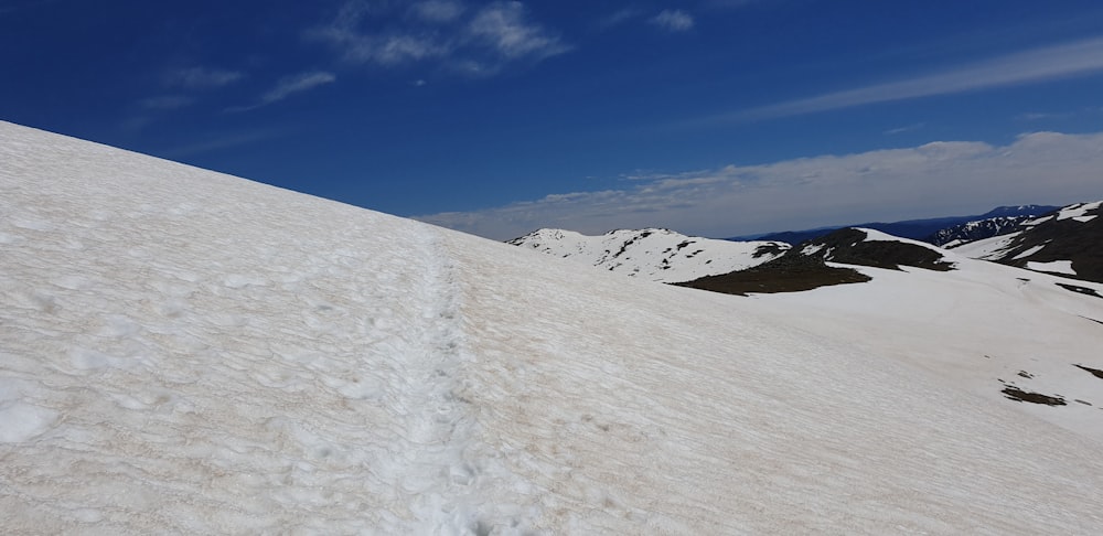 a snowy mountain with blue sky