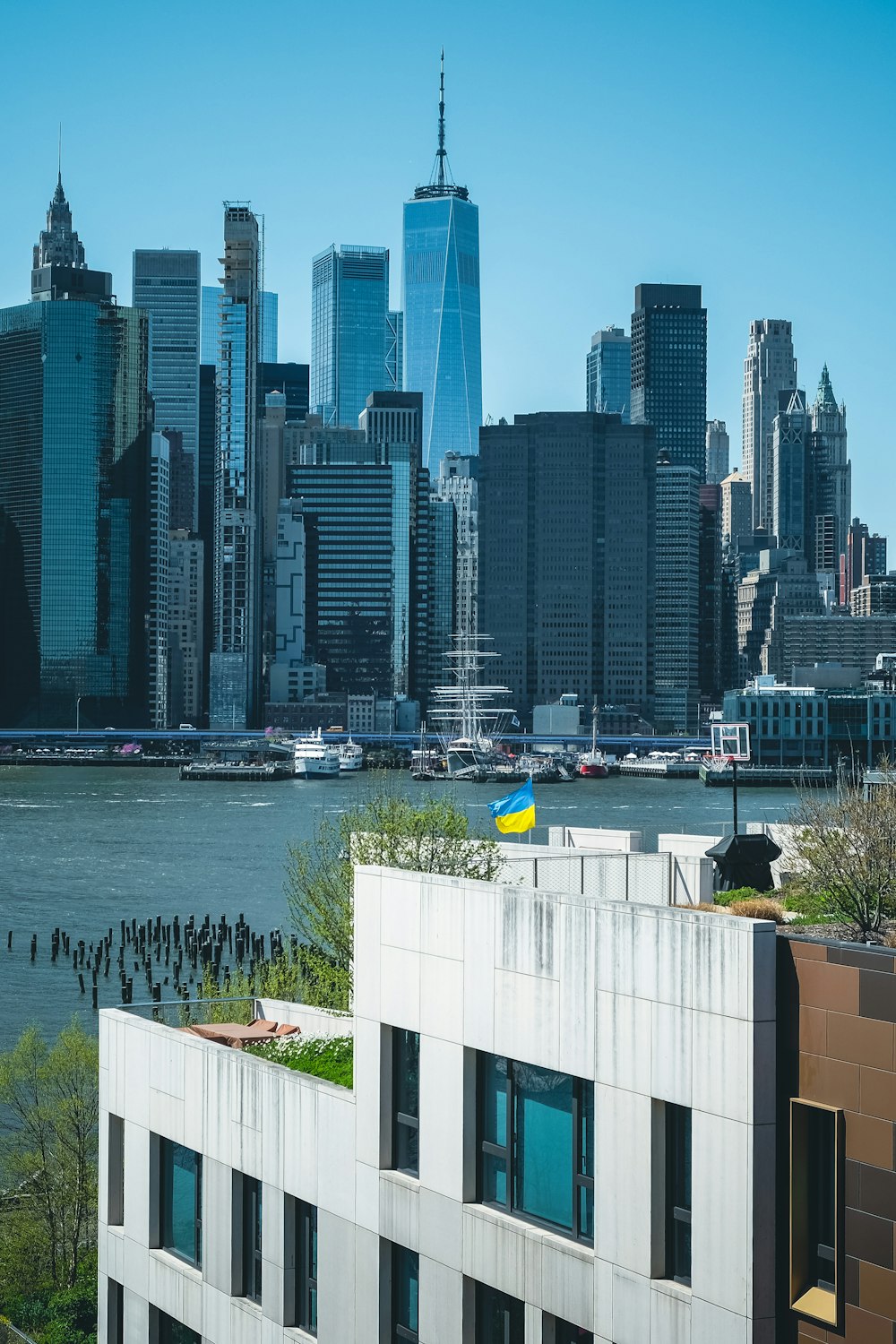 a city skyline with a body of water in the foreground