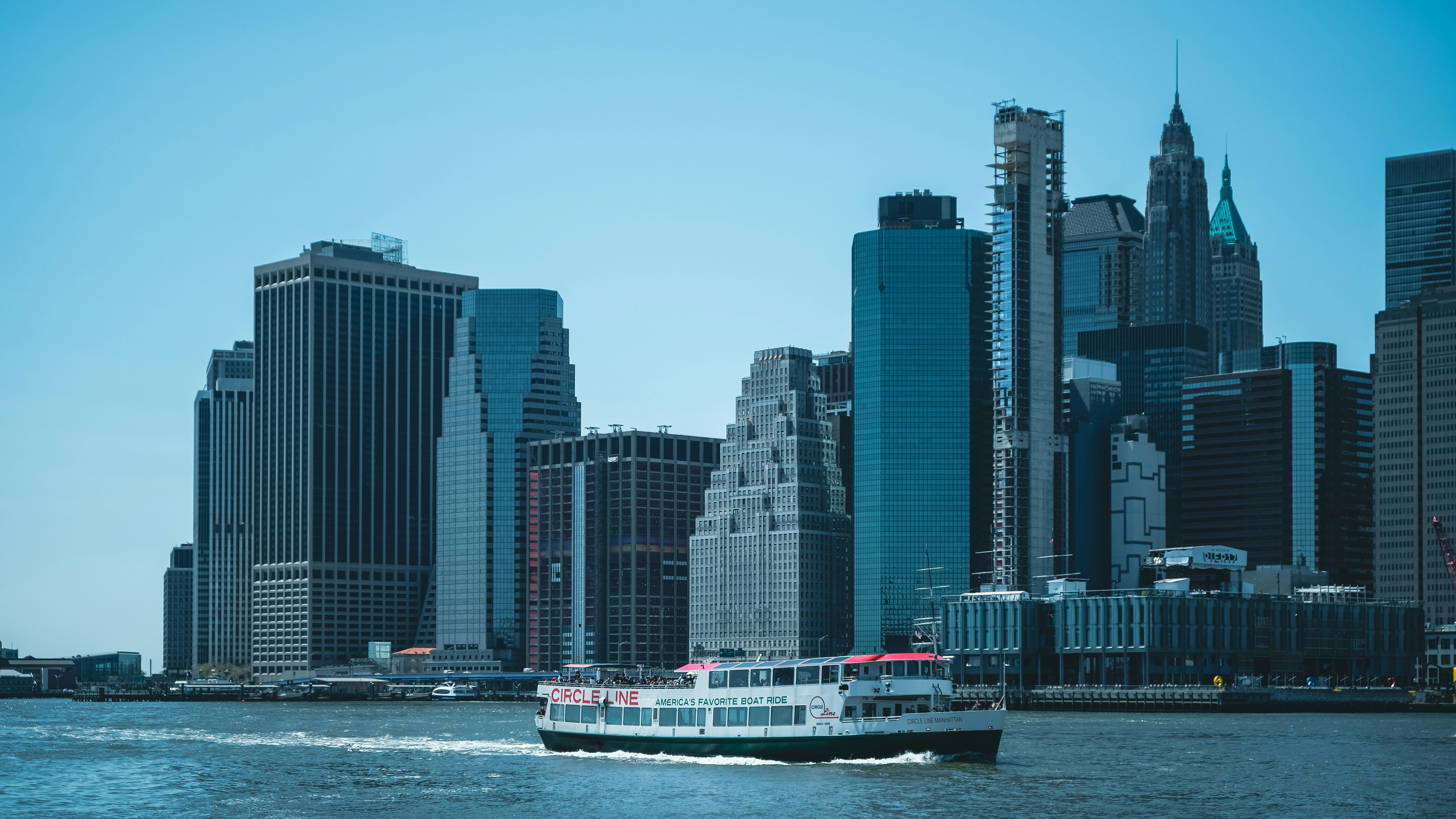 a boat in the water with a city in the background