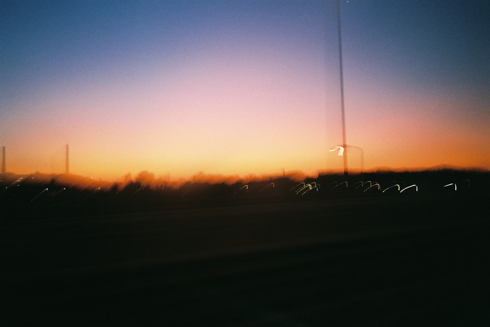 a sunset over a field