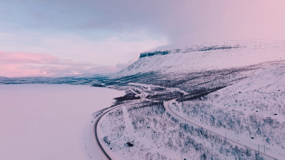 a snowy landscape with a road