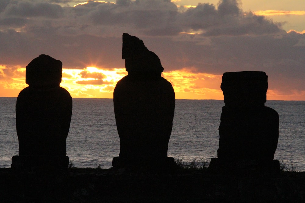 a group of statues overlooking the water