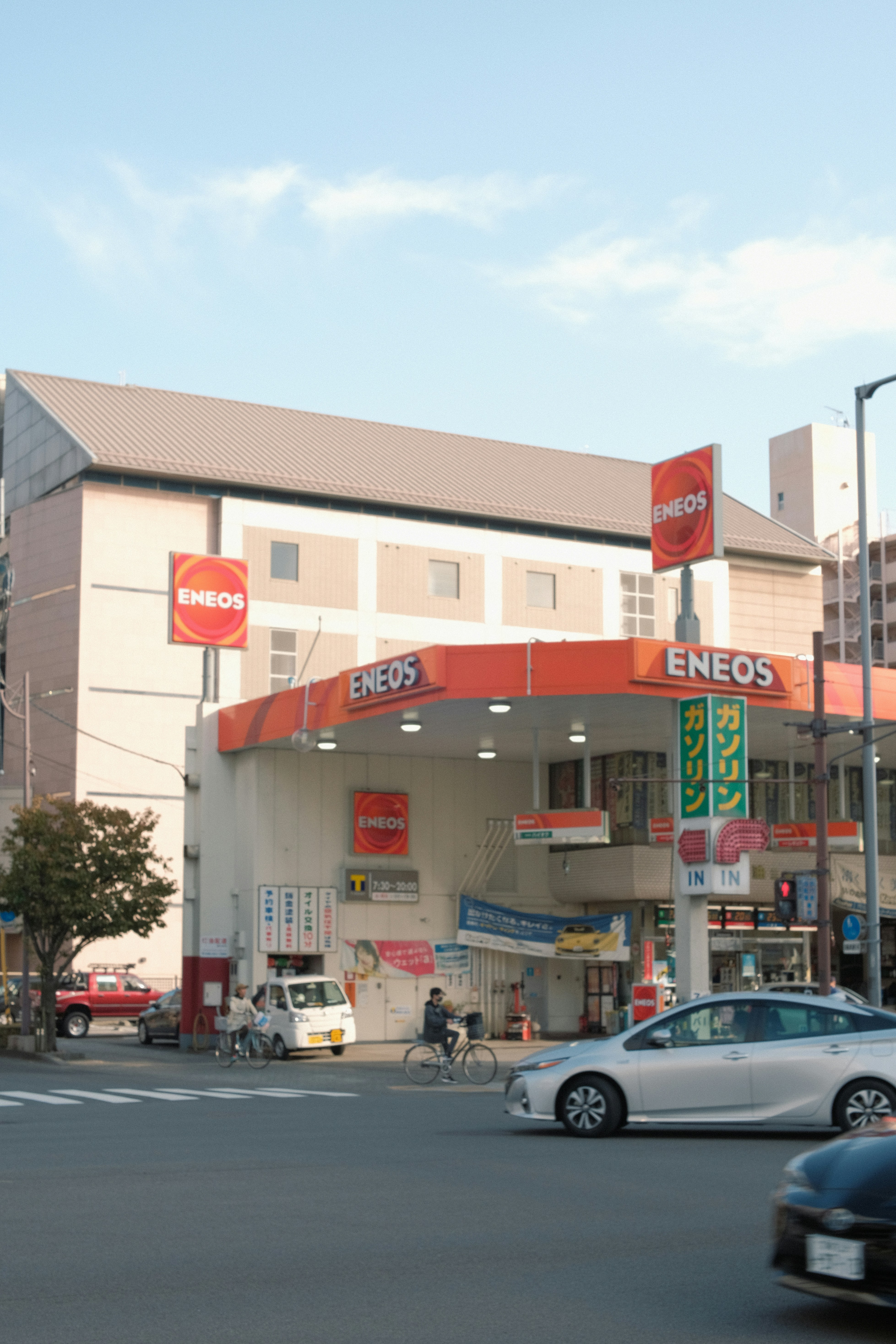a store front with cars and people