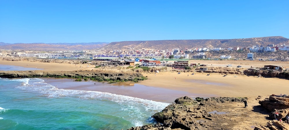 a beach with buildings and water