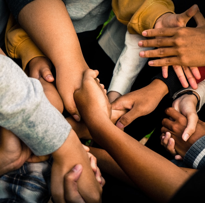 a group of people holding hands