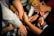 A group of diverse hands intertwined and held together, symbolizing unity and collaboration. The hands appear to belong to people of different backgrounds, conveying a powerful sense of community and support.