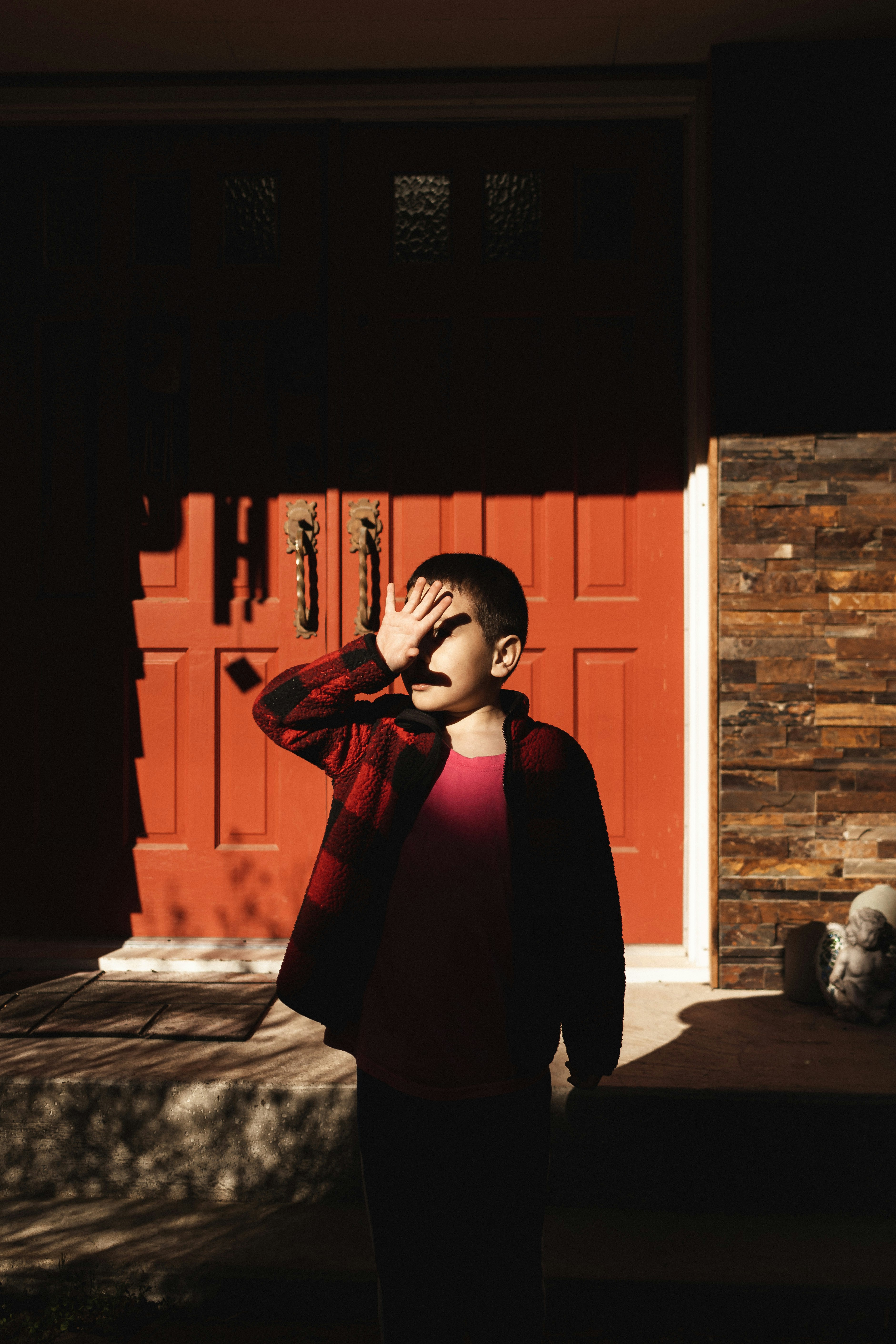 Person Standing in Front of a Red Door