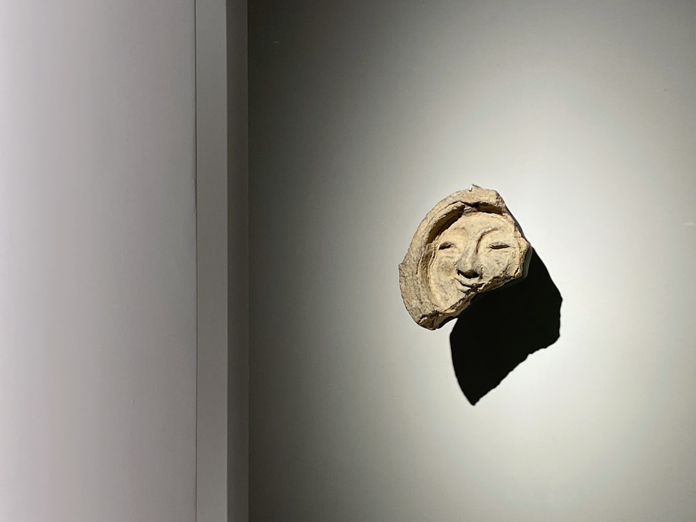 a stone head on a wall