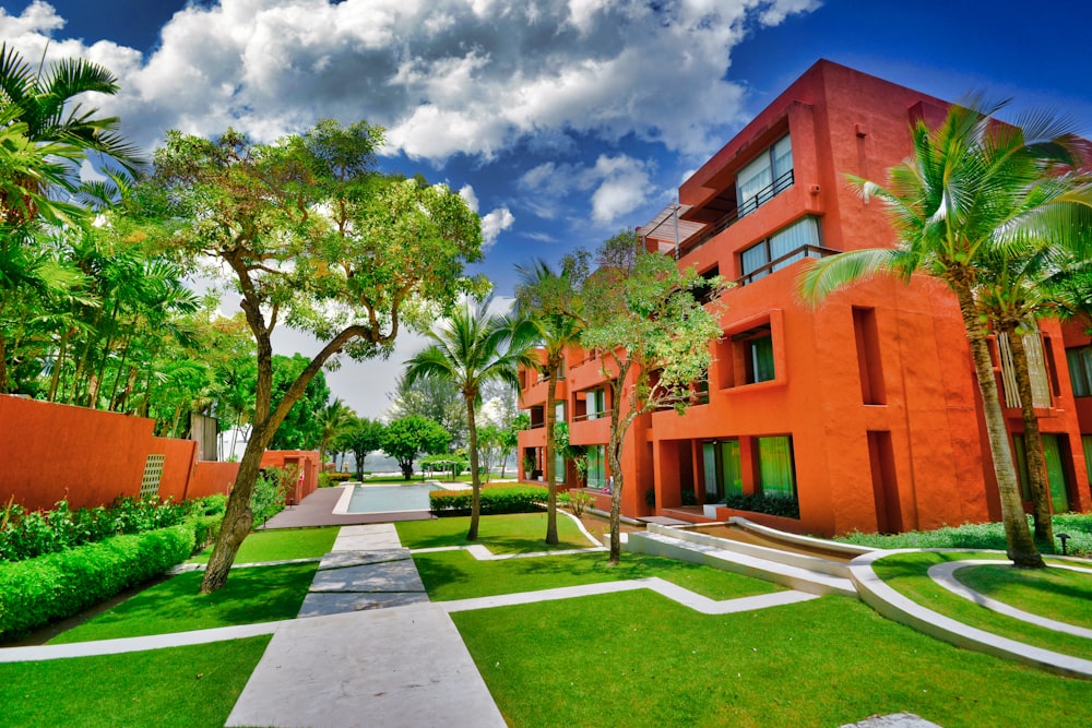 a building with palm trees and grass