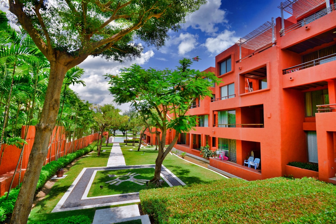 a building with trees and grass, Luxury seaside condominiums in Thailand