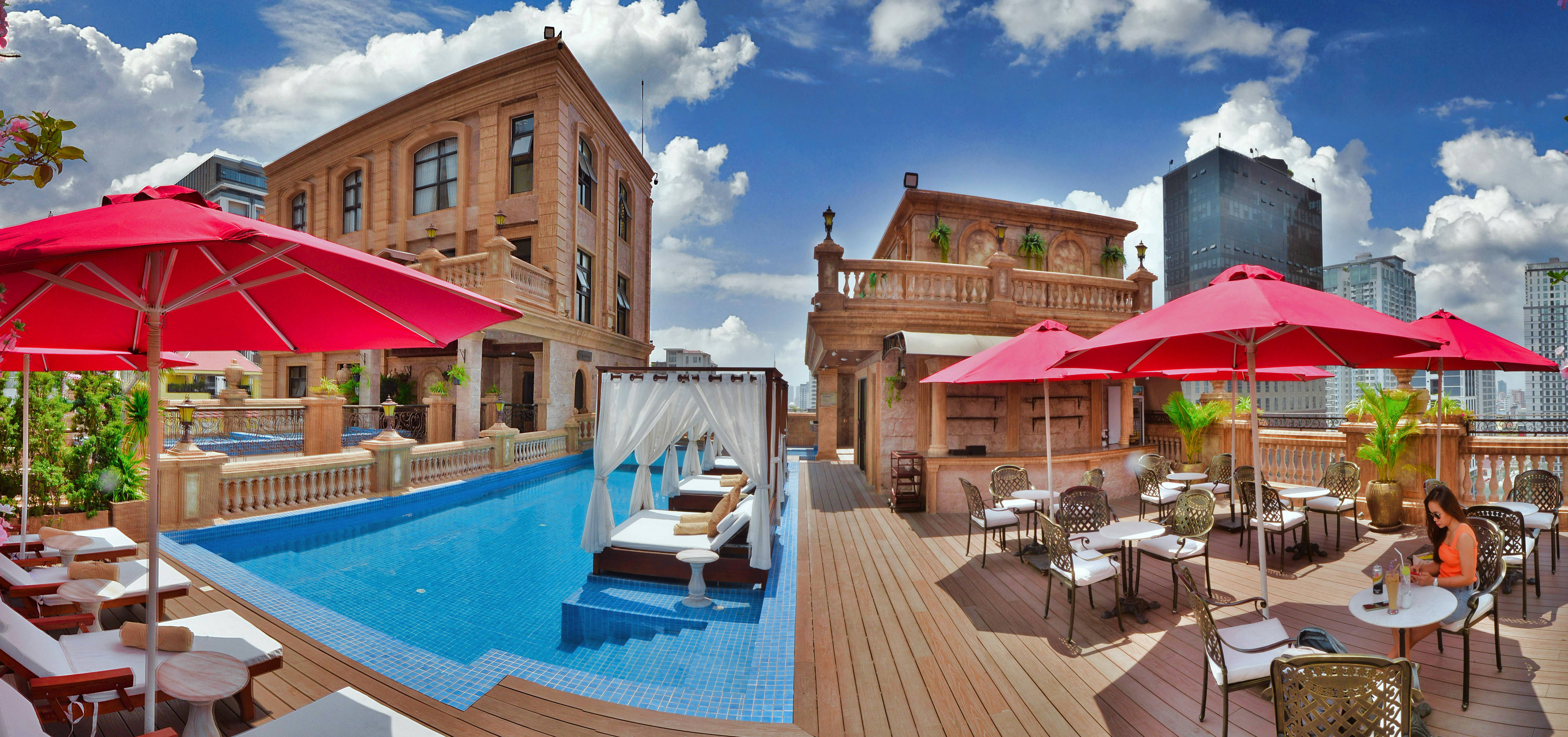 a pool with tables and chairs next to it