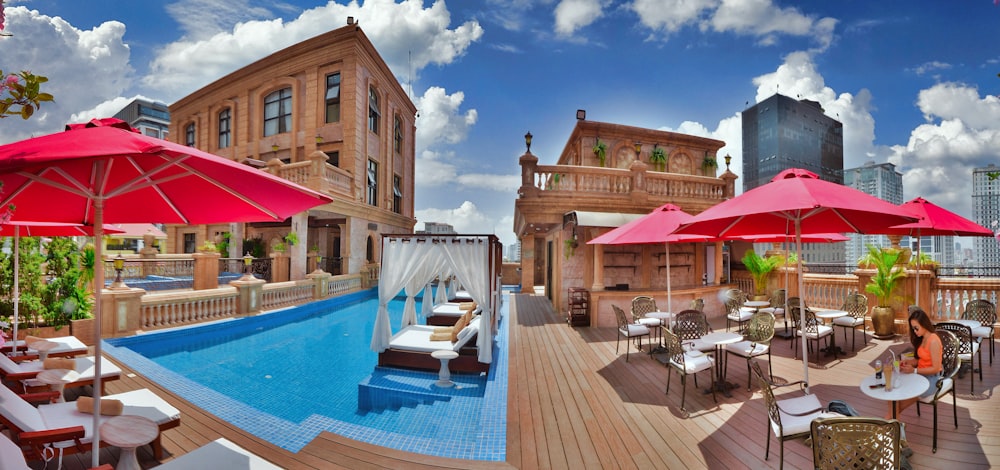 a pool with tables and chairs next to it