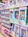 A store shelf filled with various boxed dolls and toy sets. The packaging features colorful designs and illustrations, with several dolls in different outfits visible through transparent windows. Brands like 'Little Lacee' and 'Unity Girl' are prominently displayed, offering themed sets such as baby dolls and doctor kits.