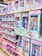 A store shelf filled with various boxed dolls and toy sets. The packaging features colorful designs and illustrations, with several dolls in different outfits visible through transparent windows. Brands like 'Little Lacee' and 'Unity Girl' are prominently displayed, offering themed sets such as baby dolls and doctor kits.