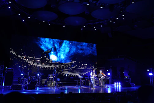 An intimate theatrical scene with actors performing a visionary narrative on stage.