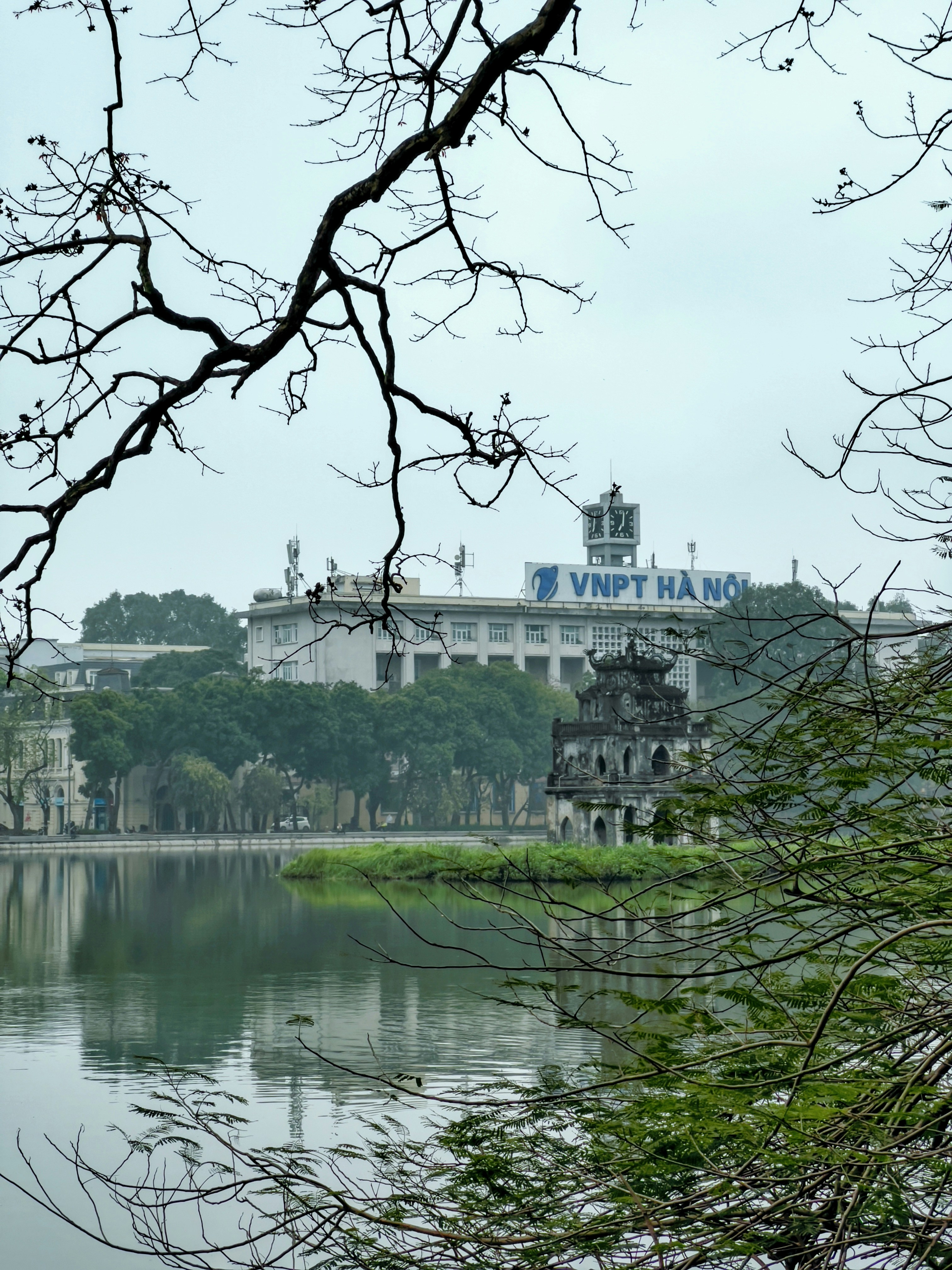 a building with a tower by a body of water