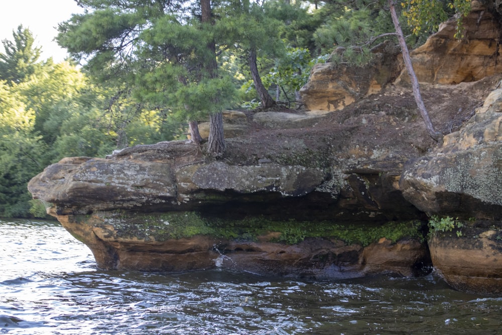 a large rock formation in the middle of a river