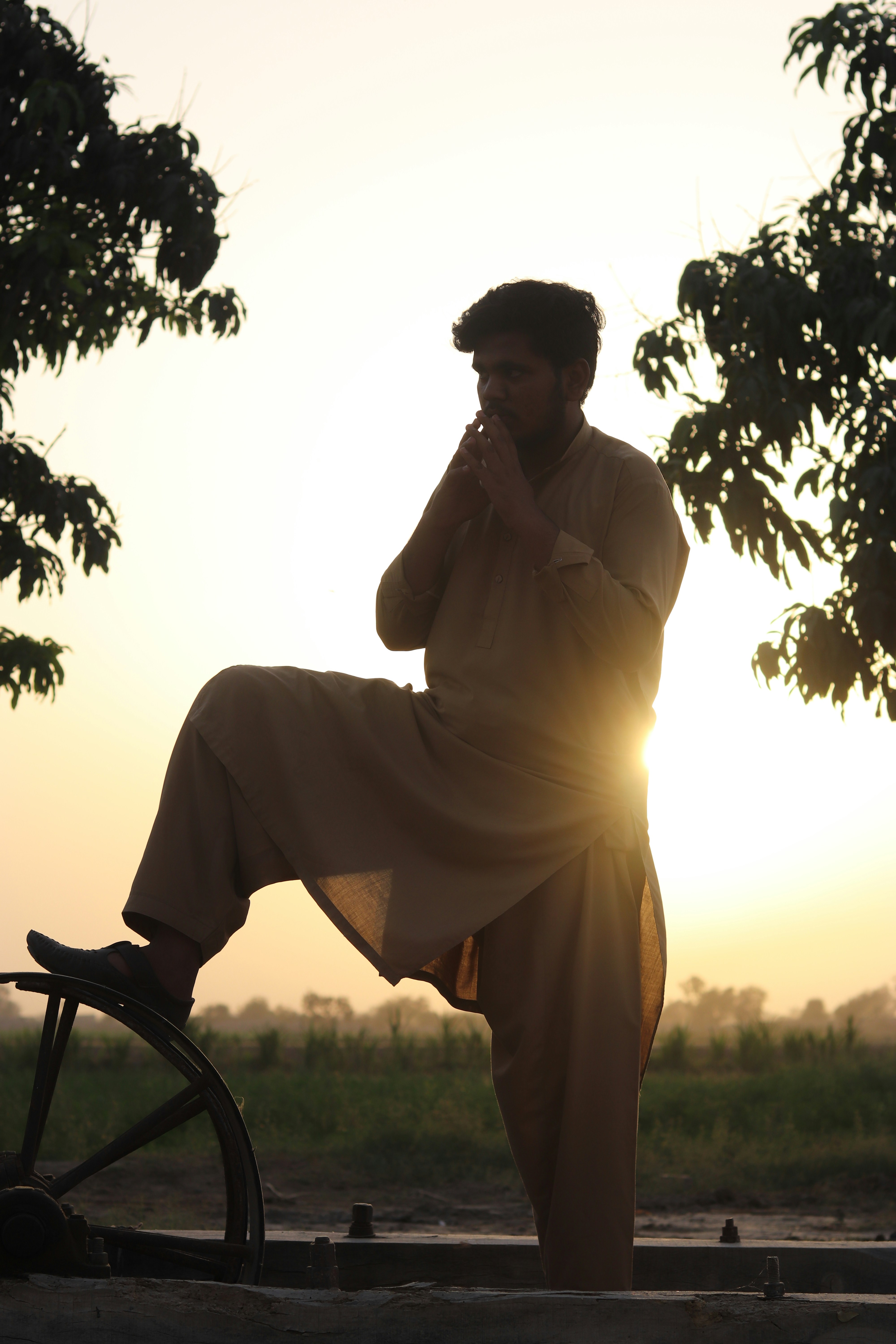 a man on a bicycle talking on a cell phone
