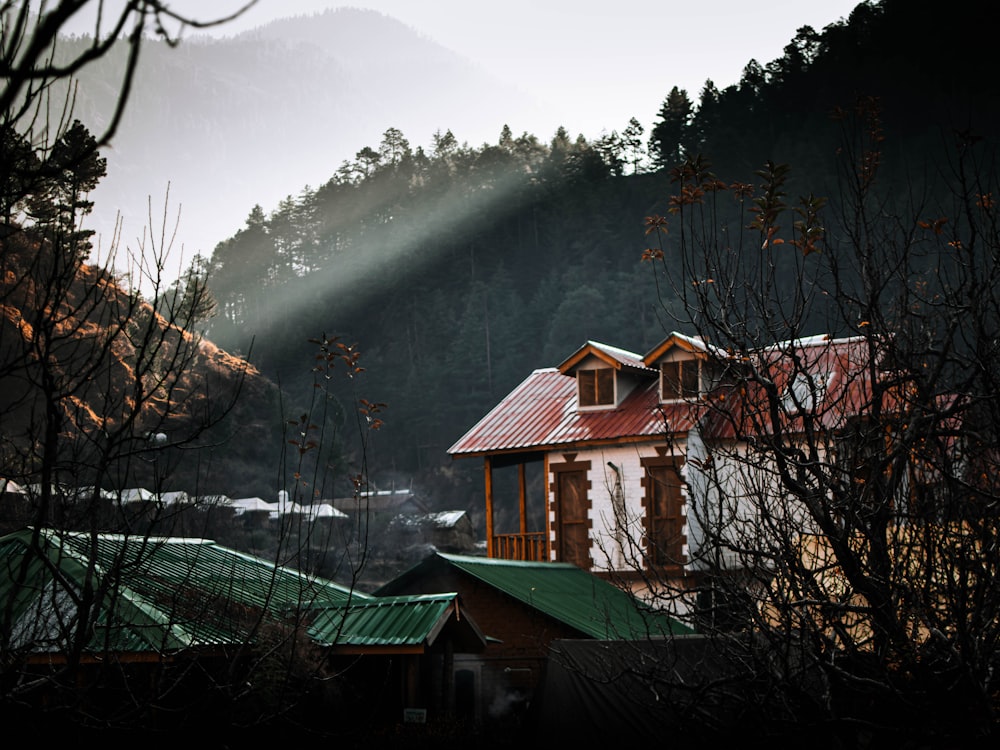 a house with a foggy mountain in the background