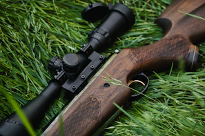 Detail of a hydrographic decorated gunstock featuring a forest camo style for hunting.