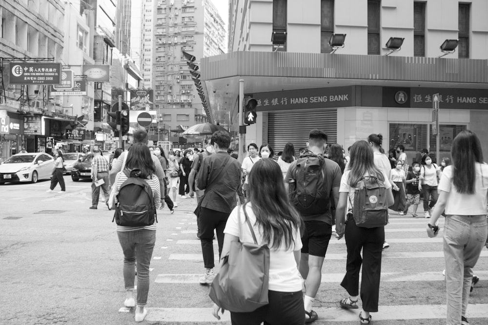a group of people walking on a busy street