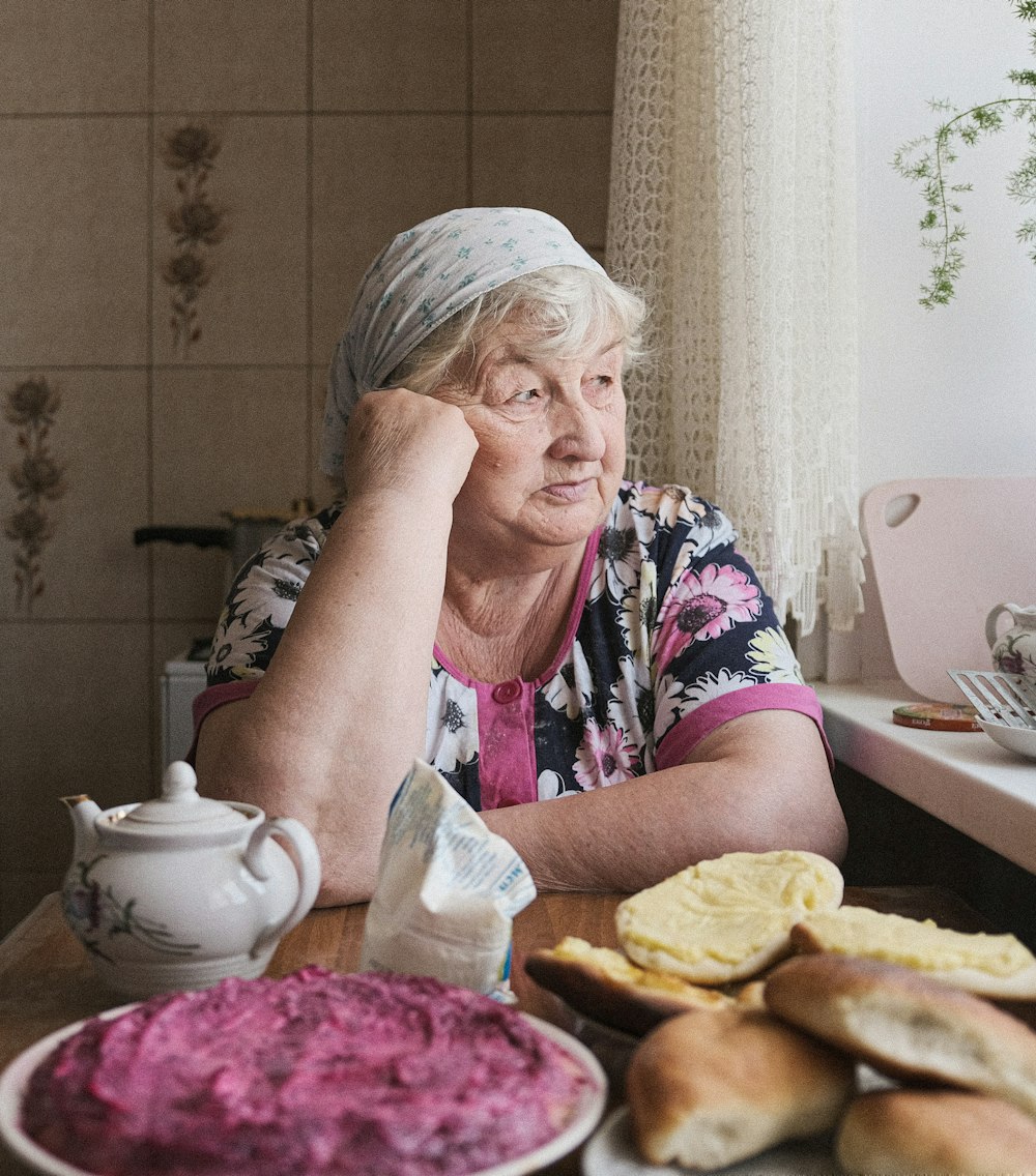 a man sitting at a table with food on it