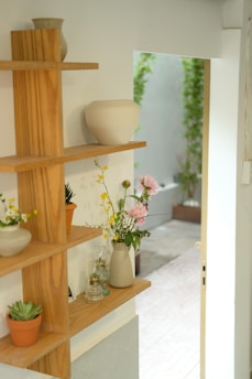 Small wooden shelf with decorative items in natural light
