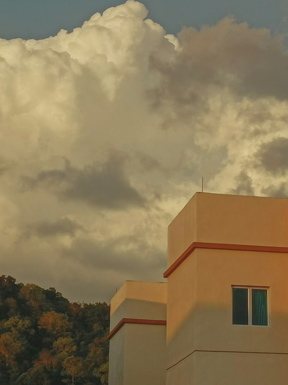 a building with a cloudy sky above