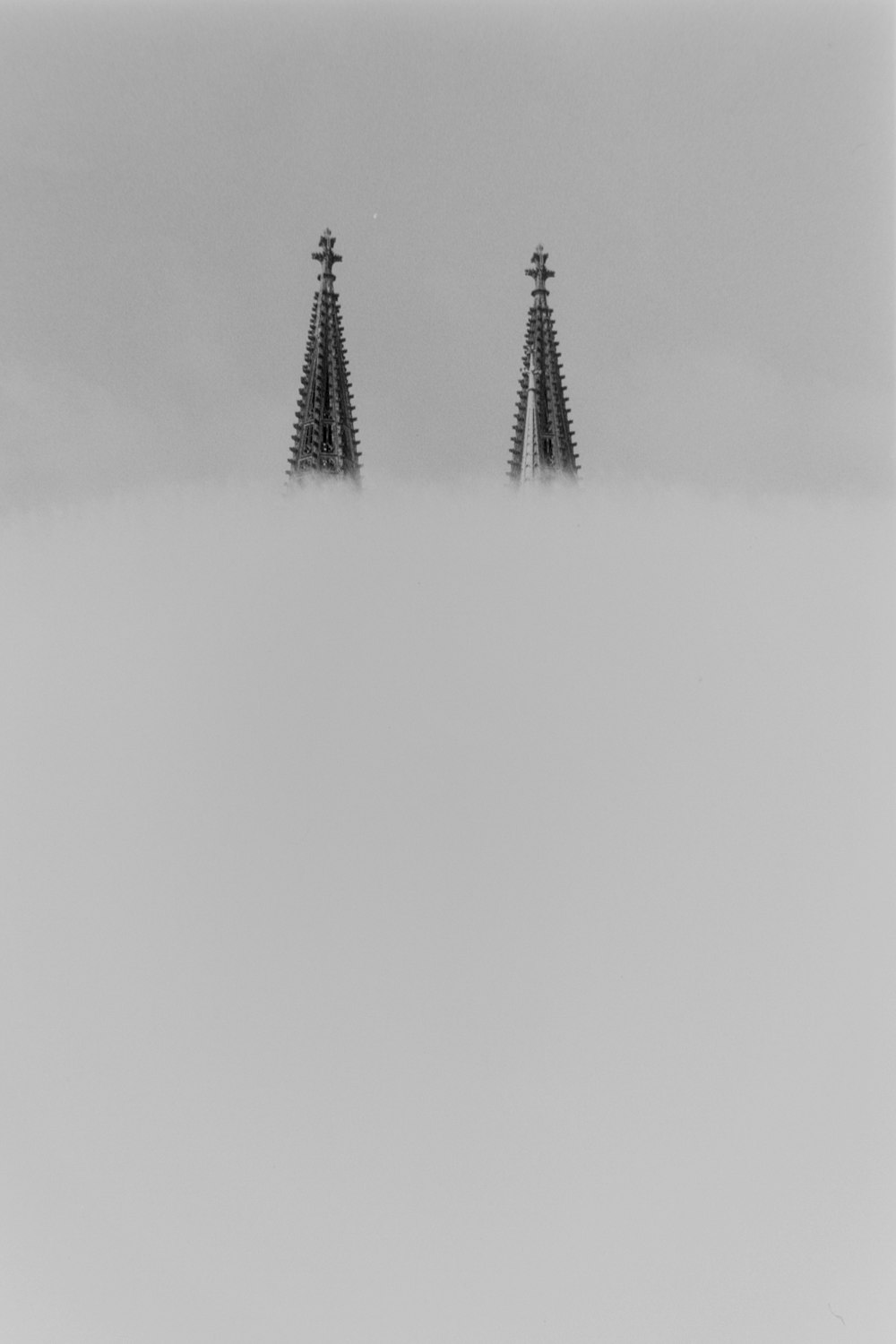 two towers with smoke coming out of them