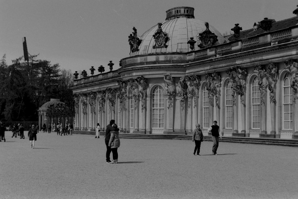 people walking in front of a building