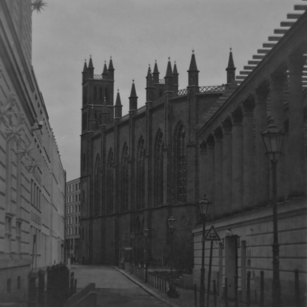 a black and white photo of a building with towers