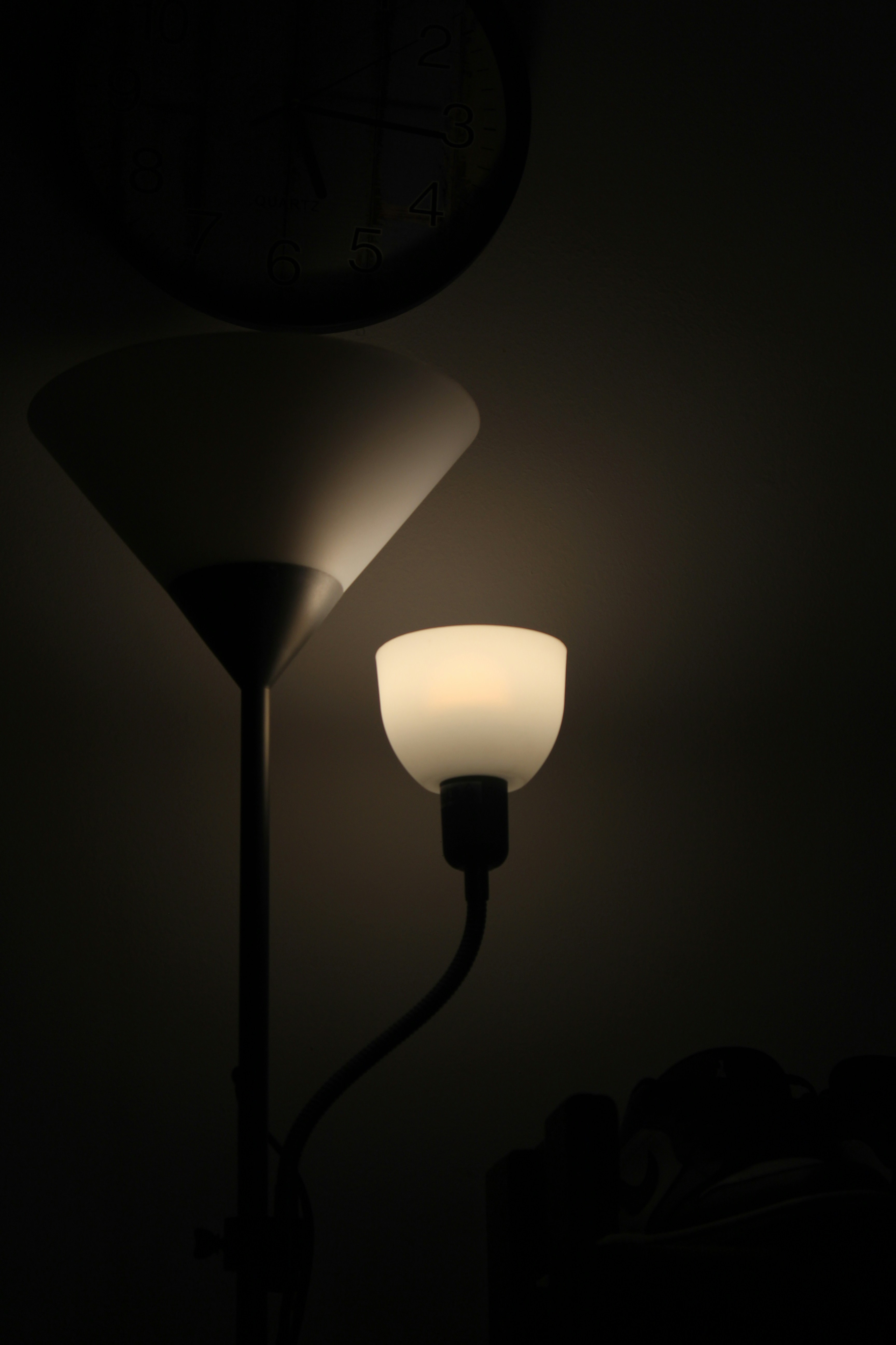 a lamp with a clock on the wall