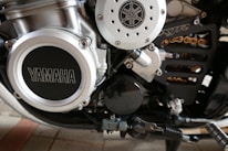 Close-up of a Yamaha motorcycle engine being serviced by a skilled mechanic.